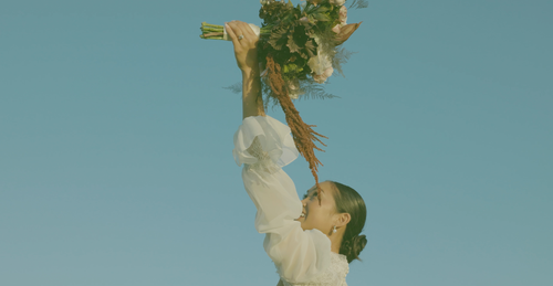 Bride lifting her bouquet