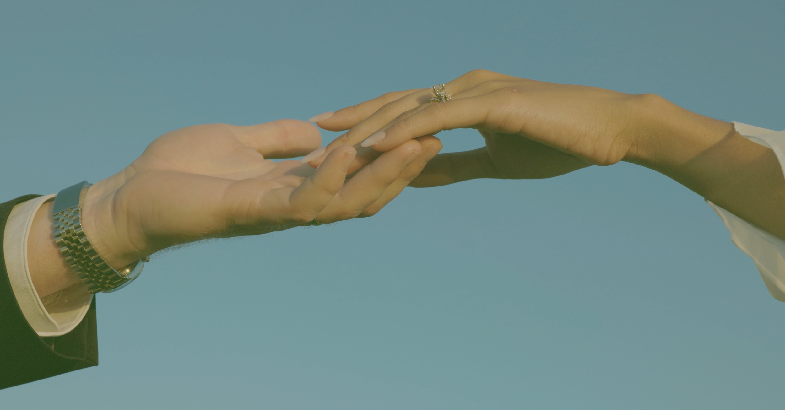 A newly married couple holding hands
